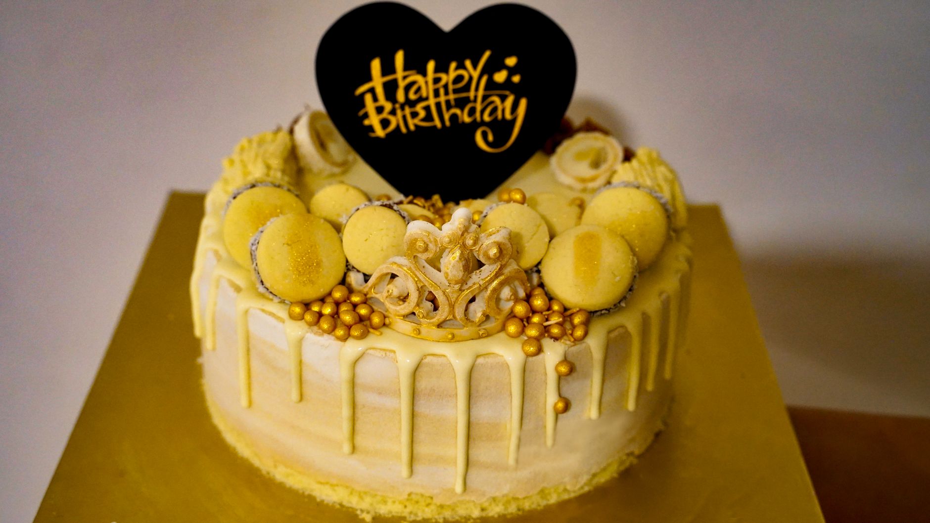 Stylish yellow birthday cake adorned with macarons and golden accents, perfect for celebrations. — How Salami Is Changing the