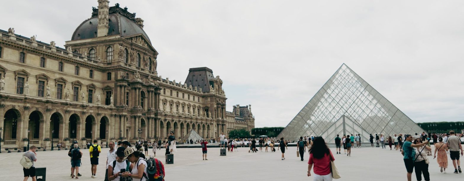 Crowds gather around the iconic Louvre and Pyramid in Paris, showcasing French architecture and culture. — Keep Your Pool Cle