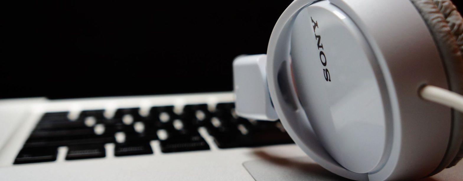 White headphones resting on a laptop keyboard, highlighting modern technology. — The Hidden Cost of Manual Systems: Why Autom
