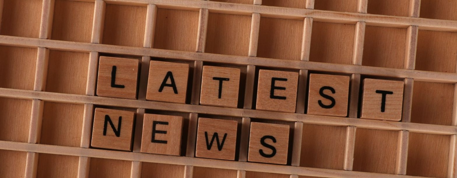 Wooden letter blocks spelling Latest News on a grid background, ideal for media themes. — Vavada promokoodide kasutamine 2026
